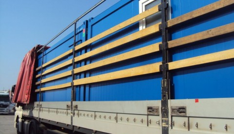 Containers in tilt trucks
